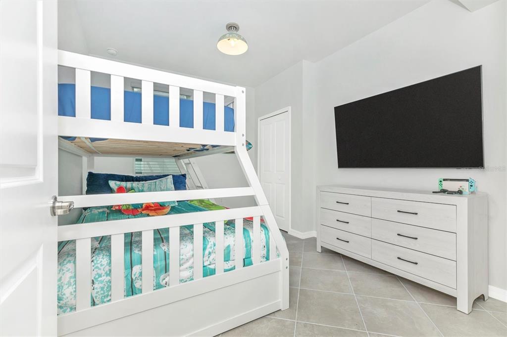 12625 Radiance Court, Unit 102 Venice, FL 34293 - Photo 41 of 99 a bedroom with furniture and a flat screen tv