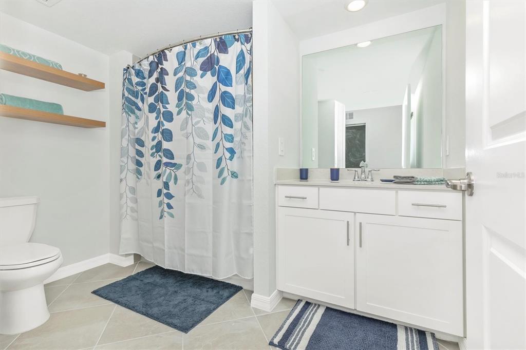 12625 Radiance Court, Unit 102 Venice, FL 34293 - Photo 43 of 99 a bathroom with a sink a toilet and a mirror