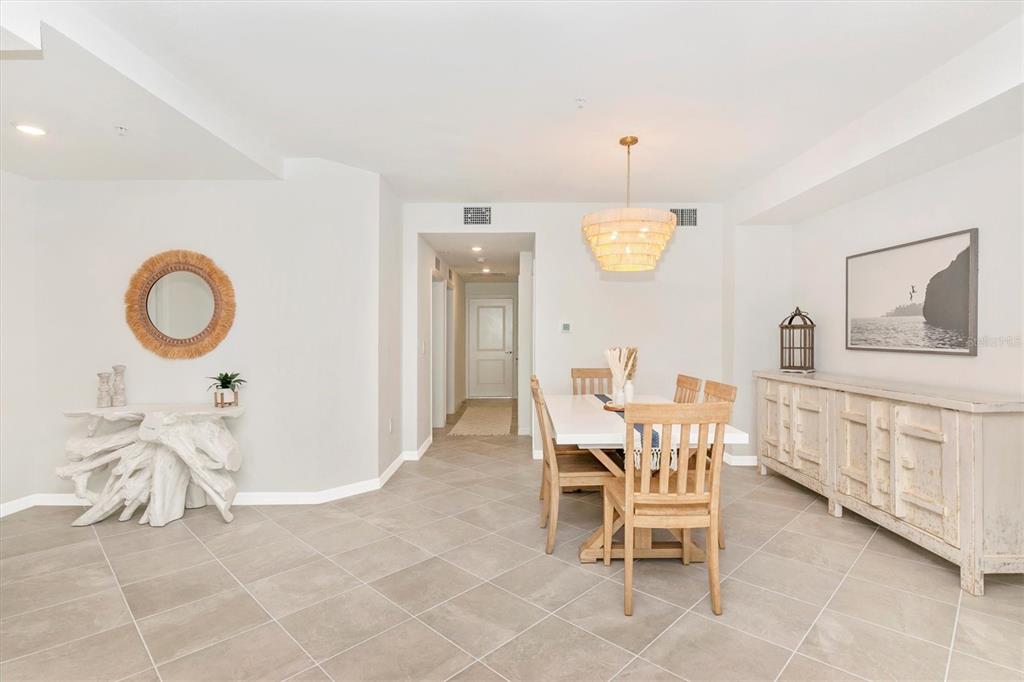 12625 Radiance Court, Unit 102 Venice, FL 34293 - Photo 7 of 99 a view of a dining room with furniture and chandelier