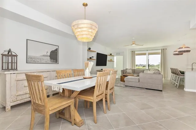 a kitchen with stainless steel appliances a table chairs and a chandelier