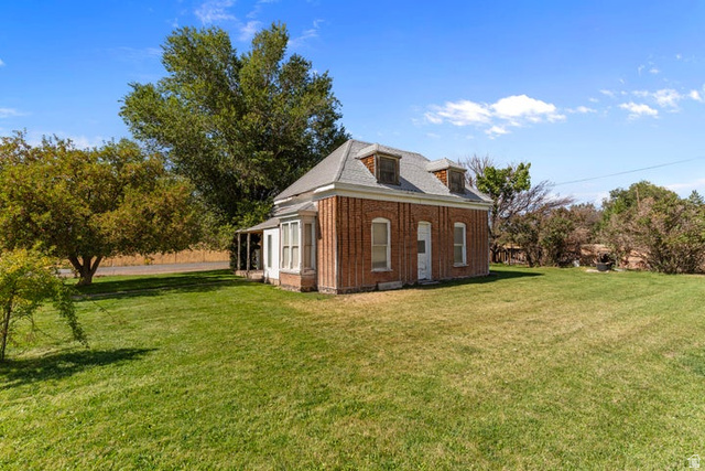 482 West 100 N Street Beaver, UT 84713 - Photo 1 of 41 View of side of property with a yard and brick siding