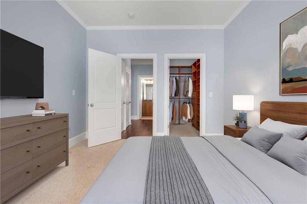 1055 Piedmont Avenue Northeast, Unit 114 Atlanta, GA 30309 - Photo 15 of 40 a bedroom with a bed and a flat screen tv