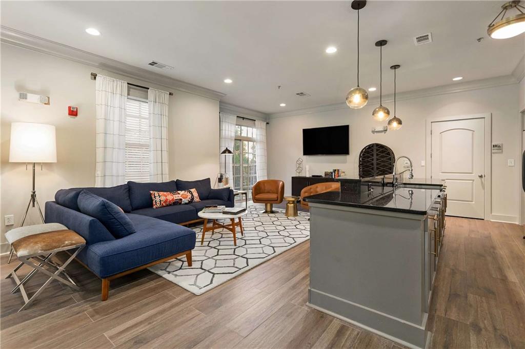 1055 Piedmont Avenue Northeast, Unit 114 Atlanta, GA 30309 - Photo 24 of 40 a living room with furniture and a flat screen tv