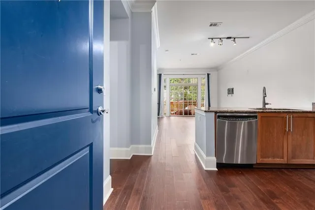 a view of a hallway with wooden floor and staircase