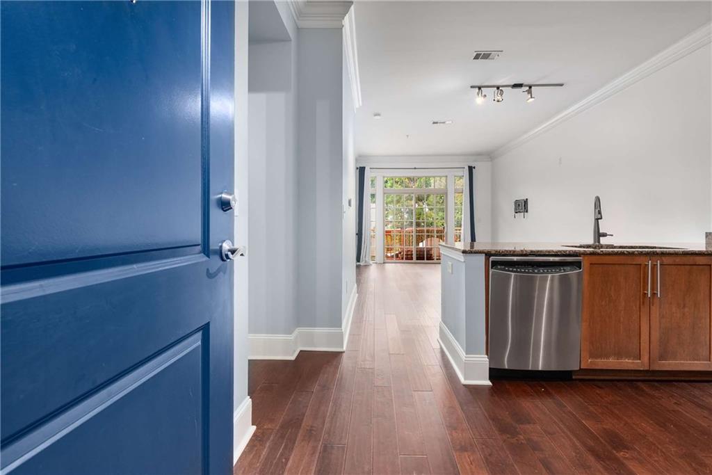 1055 Piedmont Avenue Northeast, Unit 114 Atlanta, GA 30309 - Photo 6 of 40 a view of a hallway with wooden floor and staircase