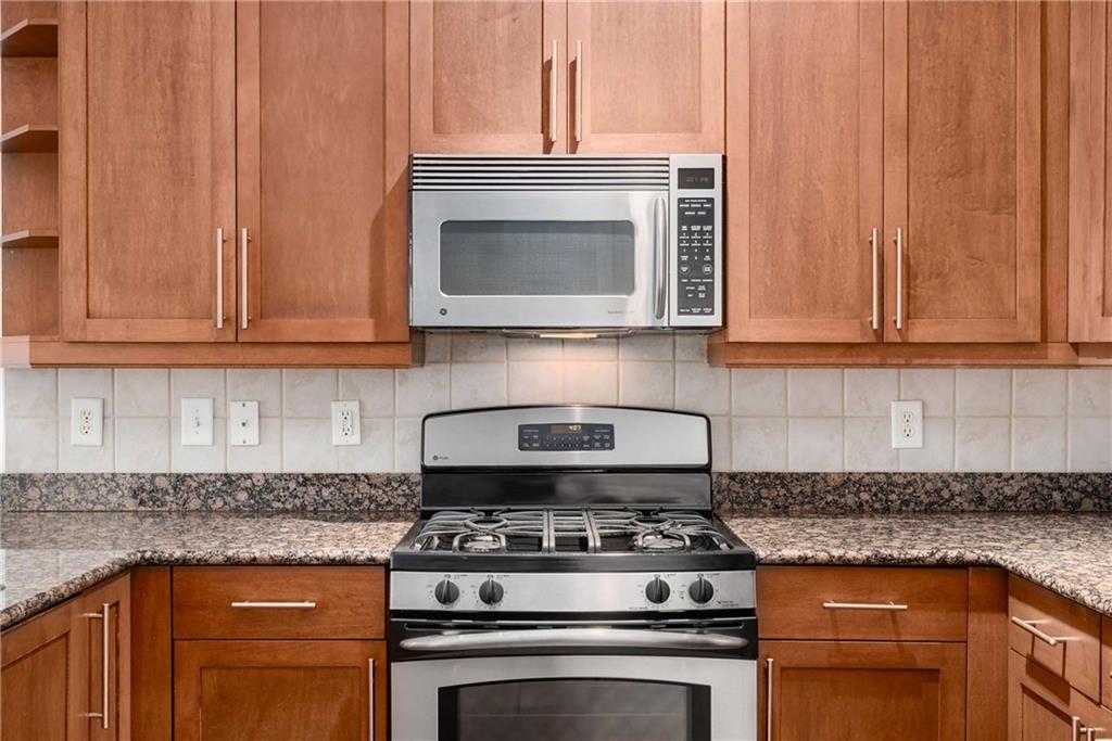 1055 Piedmont Avenue Northeast, Unit 114 Atlanta, GA 30309 - Photo 7 of 40 a stove top oven sitting inside of a kitchen