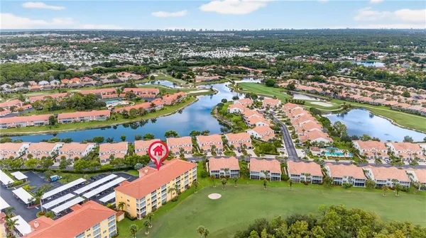 an aerial view of residential houses with outdoor space and swimming pool
