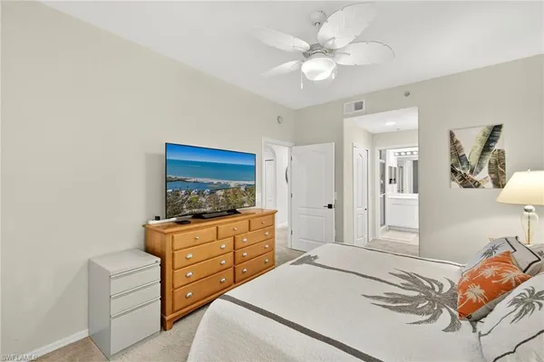 a bedroom with a bed and a dresser in it