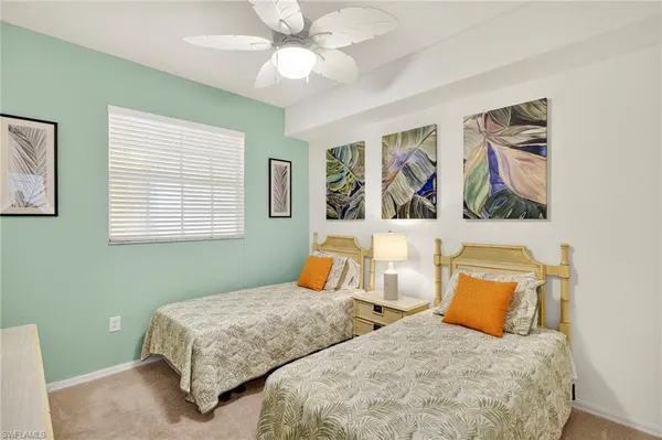 a bedroom with a bed and painting on the wall