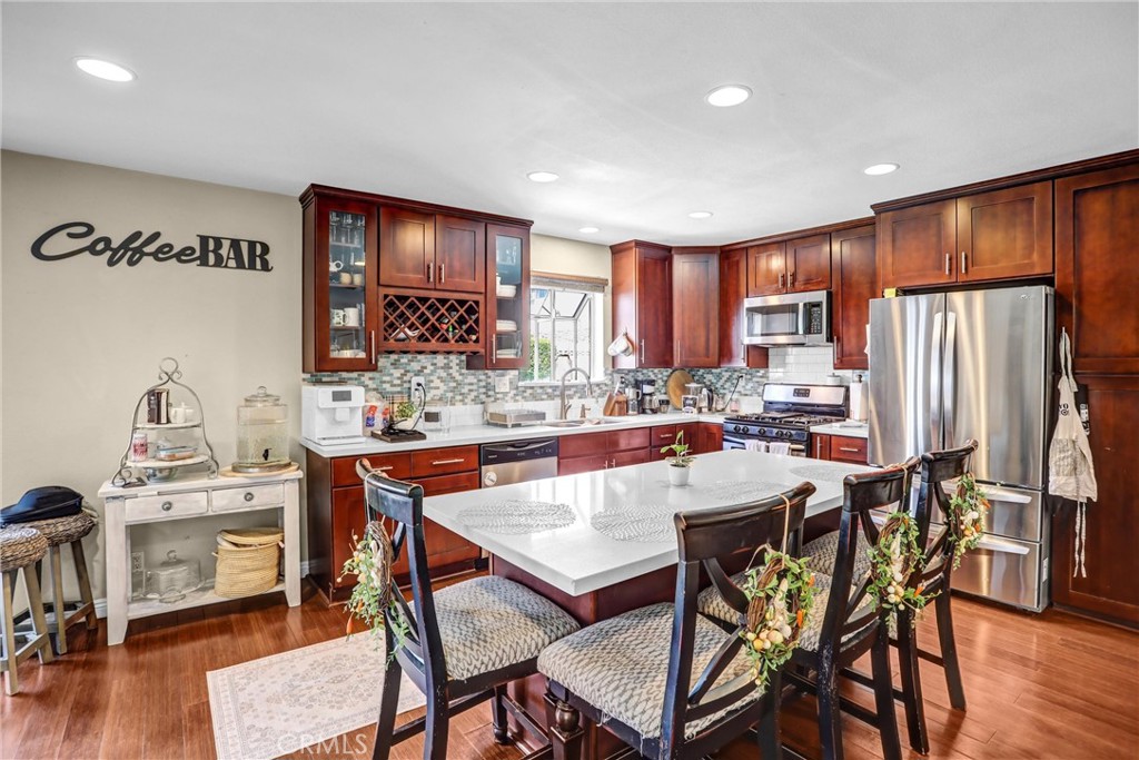 6280 Kinlock Avenue Rancho Cucamonga, CA 91737 - Photo 11 of 24 a view of a dining room with furniture and wooden floor
