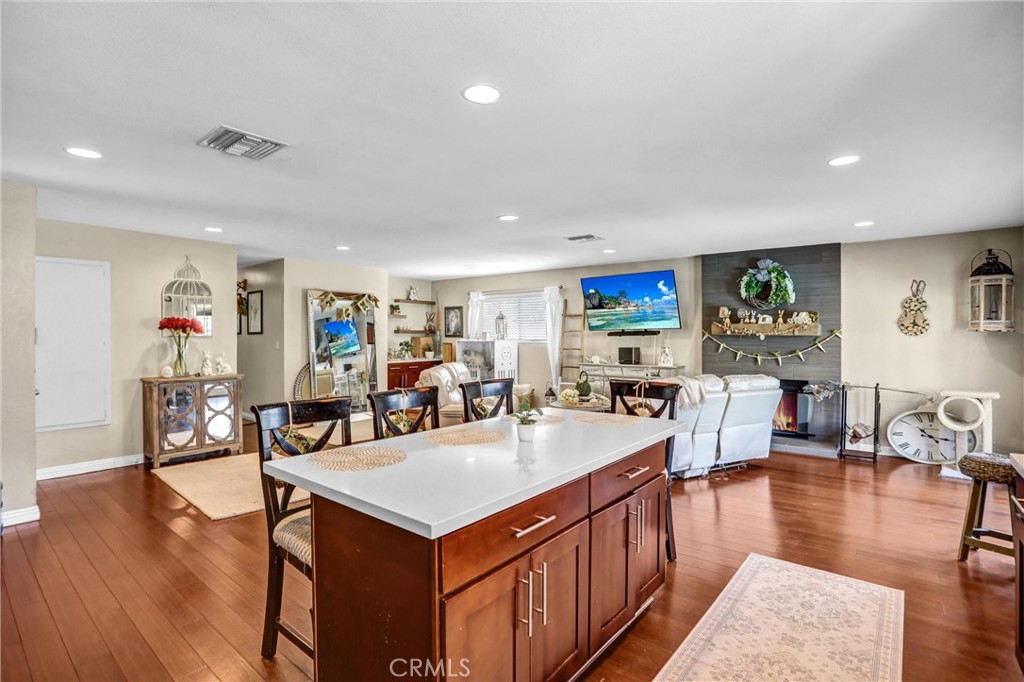 6280 Kinlock Avenue Rancho Cucamonga, CA 91737 - Photo 13 of 24 a large living room with stainless steel appliances granite countertop a table chairs and a stove