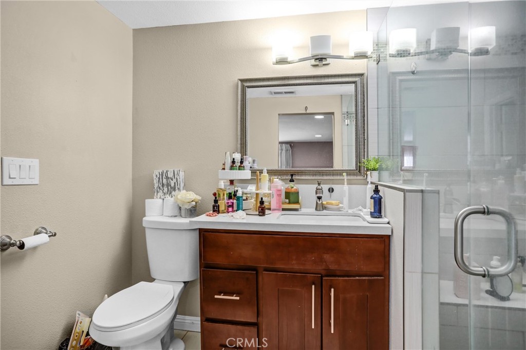 6280 Kinlock Avenue Rancho Cucamonga, CA 91737 - Photo 18 of 24 a bathroom with a toilet a sink and a mirror