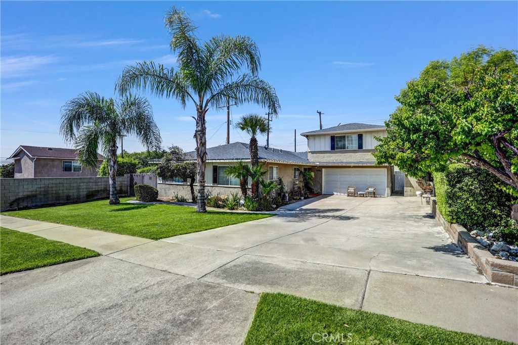 6280 Kinlock Avenue Rancho Cucamonga, CA 91737 - Photo 2 of 24 a front view of a house with garden and trees