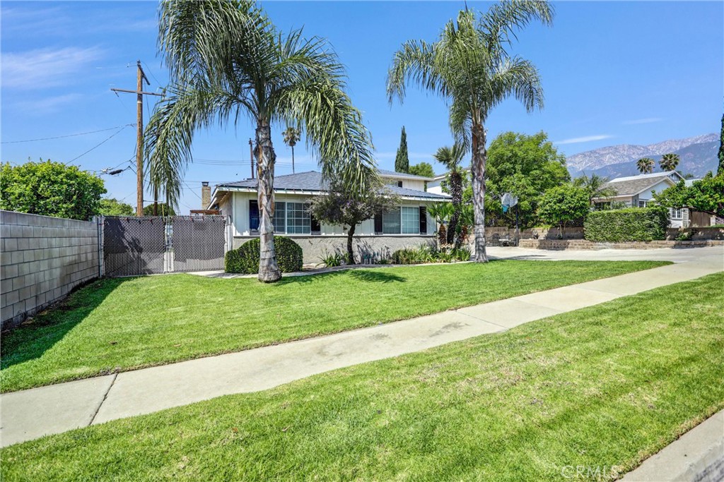6280 Kinlock Avenue Rancho Cucamonga, CA 91737 - Photo 3 of 24 a view of a house with a yard and palm trees