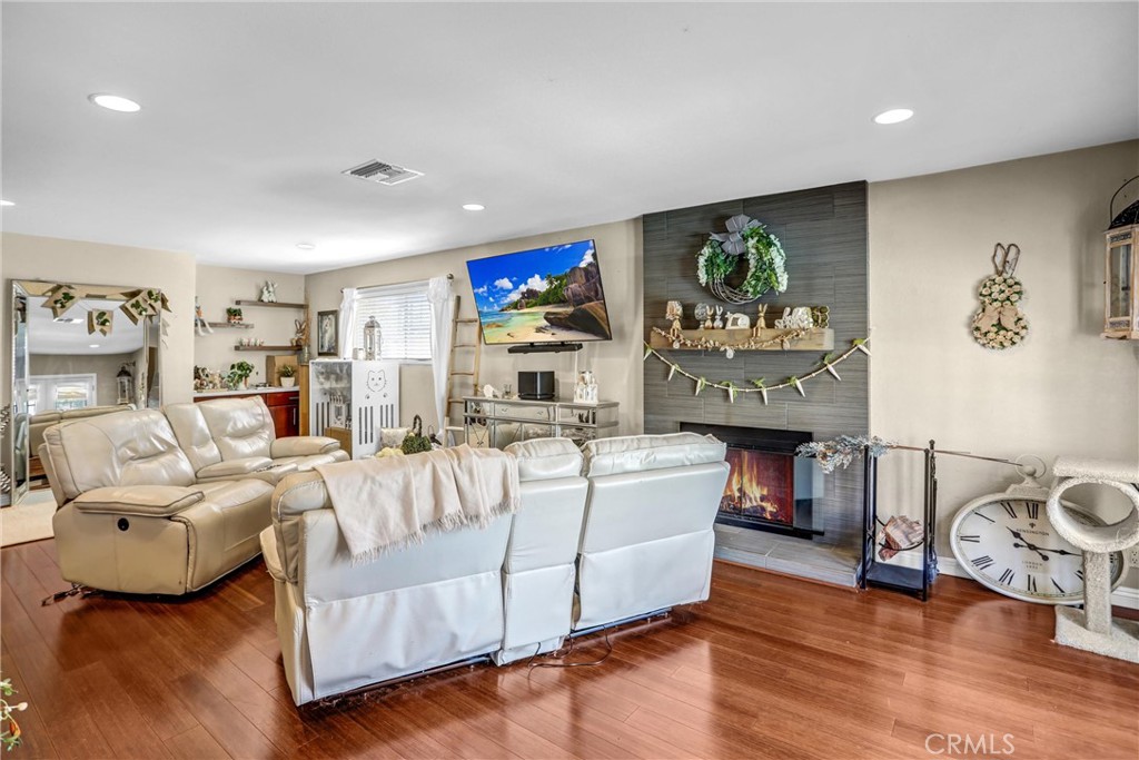 6280 Kinlock Avenue Rancho Cucamonga, CA 91737 - Photo 7 of 24 a living room with furniture a fireplace and a flat screen tv