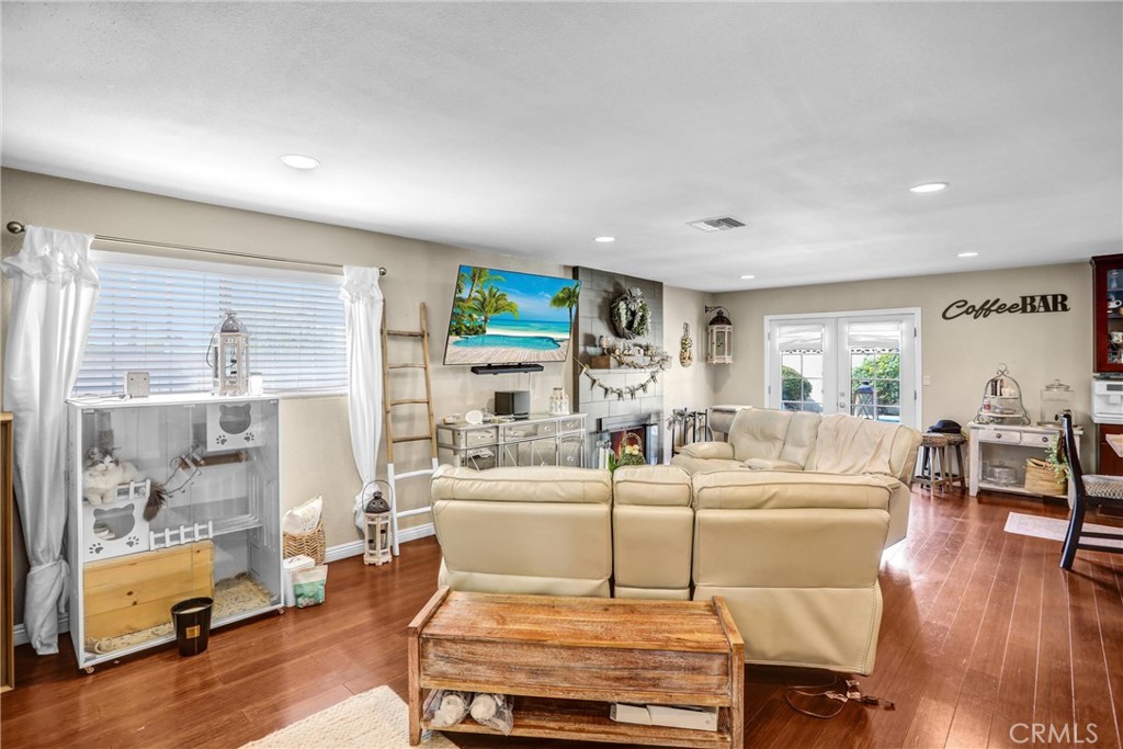 6280 Kinlock Avenue Rancho Cucamonga, CA 91737 - Photo 8 of 24 a living room with furniture a wooden floor and a large window