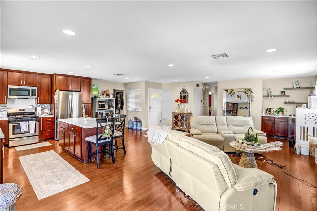 6280 Kinlock Avenue Rancho Cucamonga, CA 91737 - Photo 10 of 24 a living room with lots of furniture and kitchen view