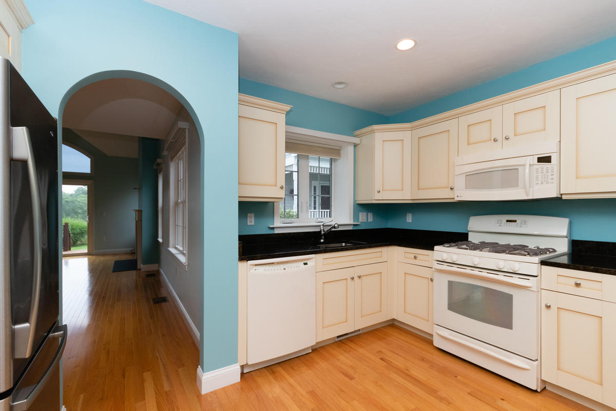 20 Prestwick Road Bourne, MA 02532 - Photo 2 of 29 a kitchen with granite countertop white cabinets and white appliances