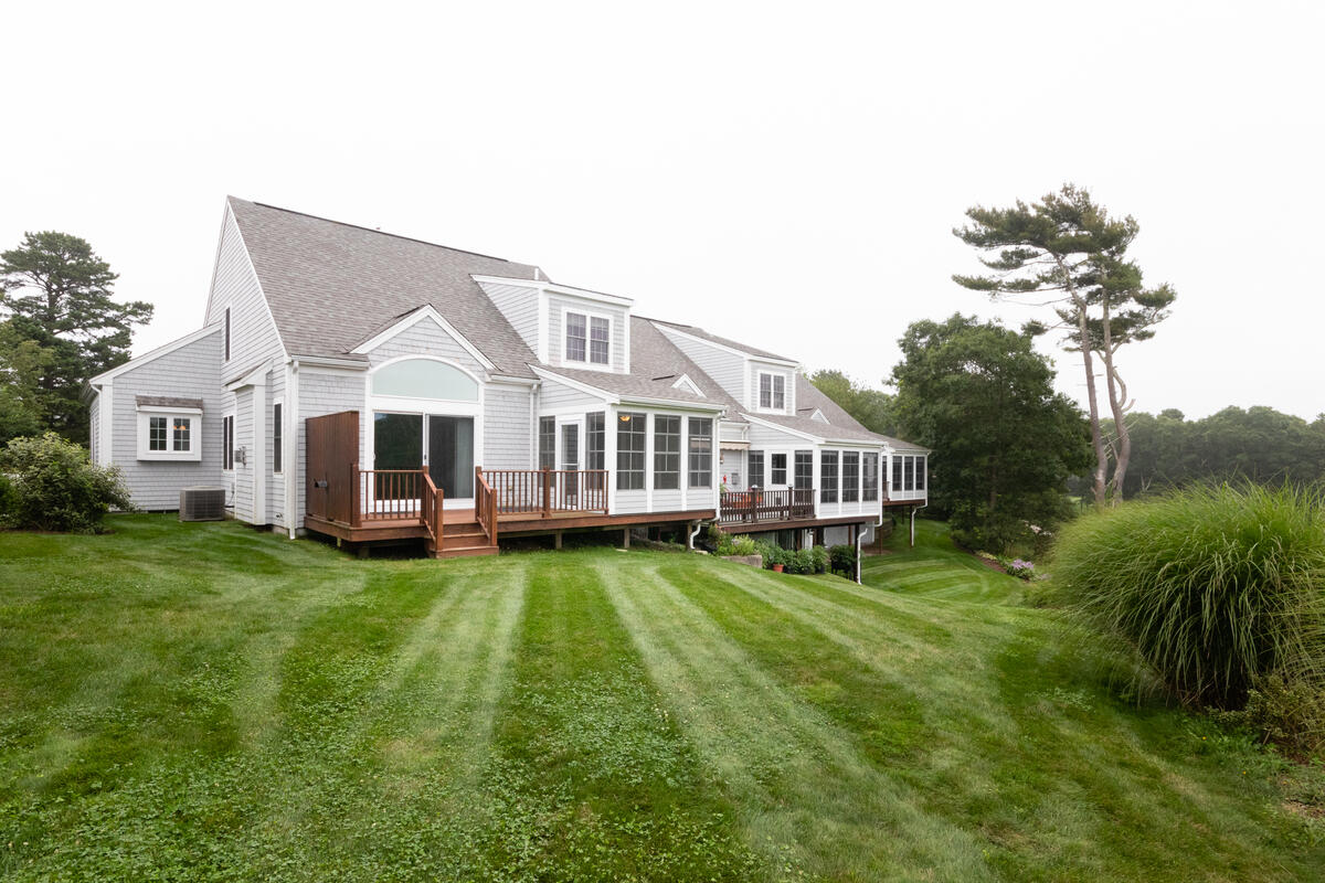 20 Prestwick Road Bourne, MA 02532 - Photo 26 of 29 a view of a house with a big yard potted plants and large tree