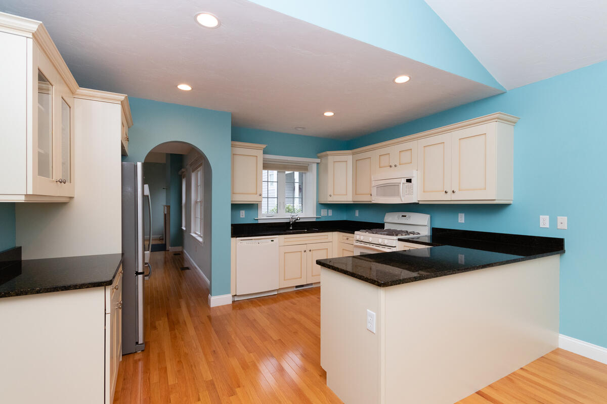 20 Prestwick Road Bourne, MA 02532 - Photo 3 of 29 a kitchen with granite countertop white cabinets and black appliances