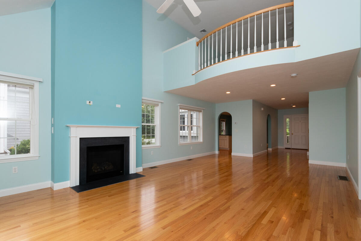 20 Prestwick Road Bourne, MA 02532 - Photo 10 of 29 a view of empty room with wooden floor and fireplace