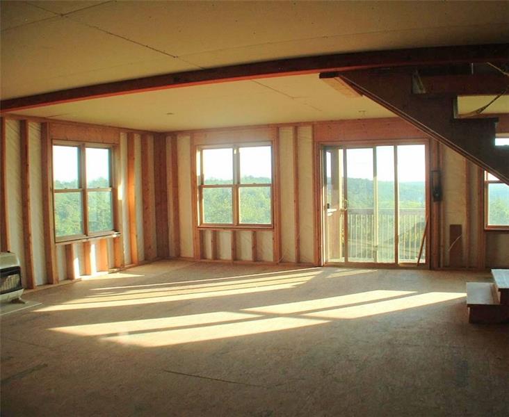 429 Burnsville Ridge Road Claysville, PA 15323 - Photo 18 of 21 Lower level of the addition is light and bright with the many double pane windows and the sliders that lead out to a small porch. Steps to the right are down a few from the main house and then up to the second floor. Owner got a great start here, now it's your turn to bring it to completion. And remember, no extra charge for that view.