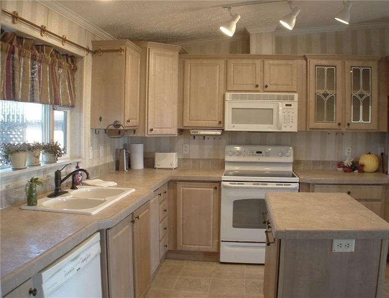 429 Burnsville Ridge Road Claysville, PA 15323 - Photo 6 of 21 This bright and cheery, neutral 14x13 kitchen is beautifully functional with an electric glass-topped range, microwave, dishwasher and nice-and-deep double bowl sink. The island adds to the already abundant cabinets and counter space. Just out of camera frame to the left is the sizable pantry.