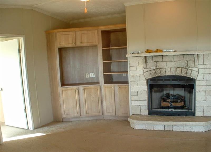 429 Burnsville Ridge Road Claysville, PA 15323 - Photo 9 of 21 The spacious living room offers a propane gas log fireplace and built-ins. The door to the left leads to the master suite.