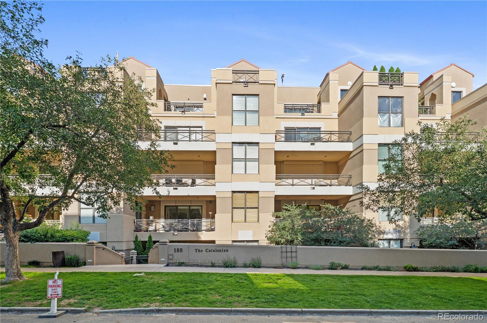 180 Cook Street, Unit 203 Denver, CO 80206 - Photo 6 of 44 a front view of a residential apartment building with a yard