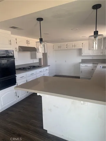 a kitchen with a sink and a refrigerator
