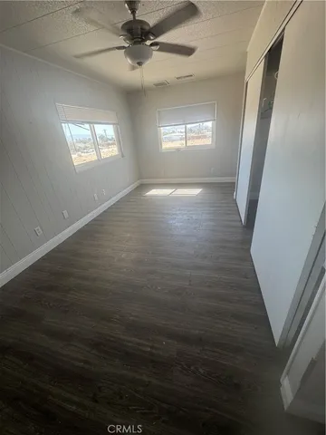 a view of room window and hardwood floor