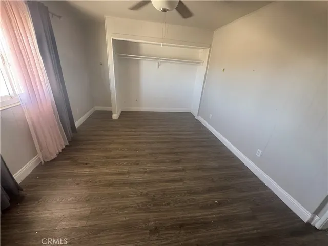 a view of a room with wooden floor and staircase
