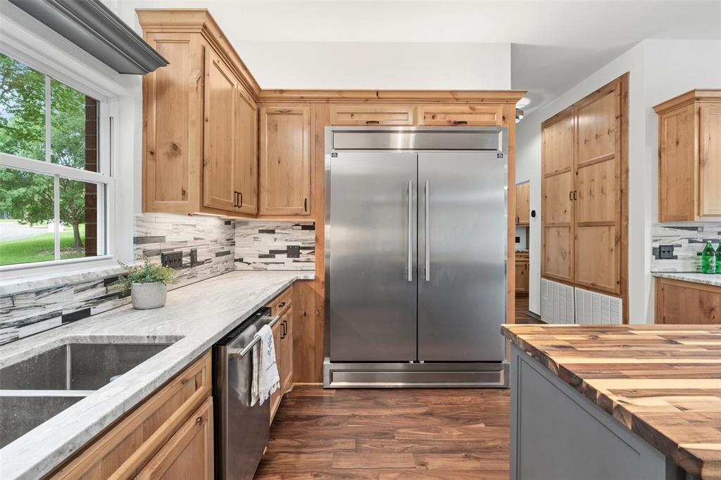 3091 Rockbridge Road McGregor, TX 76657 - Photo 12 of 40 a kitchen with stainless steel appliances granite countertop a sink and a refrigerator