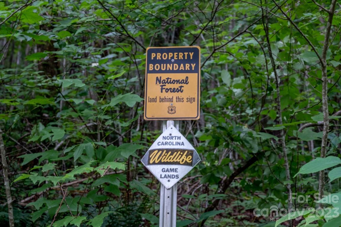 427 Quarry Road, Unit 22 Lake Toxaway, NC 28747 - Photo 12 of 21 a sign on the side of the tree