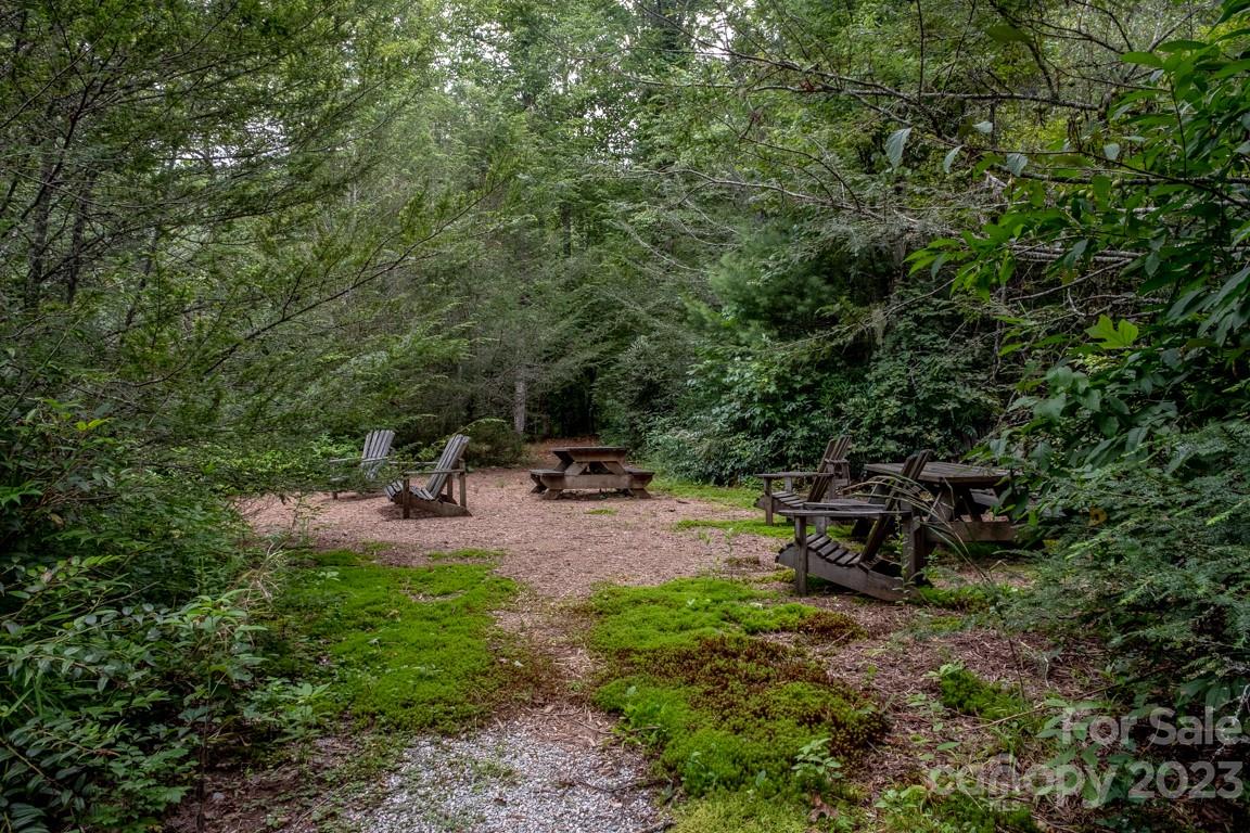 427 Quarry Road, Unit 22 Lake Toxaway, NC 28747 - Photo 19 of 21 a view of swimming pool with lawn chairs and a fire pit