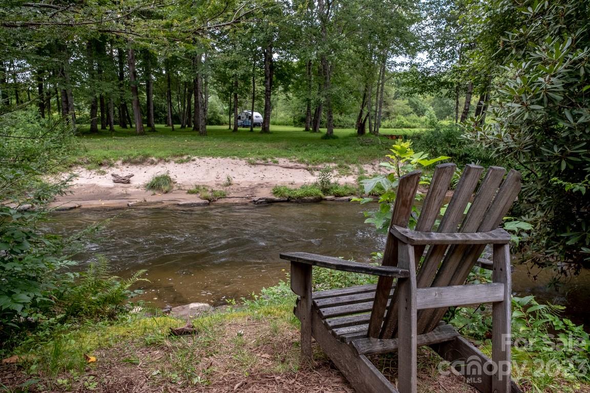 427 Quarry Road, Unit 22 Lake Toxaway, NC 28747 - Photo 21 of 21 a wooden bench sitting in the middle of a lake