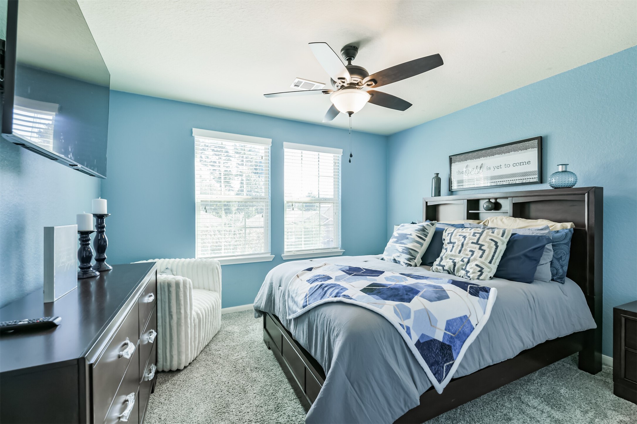 24047 Schults Meadow Lane Spring, TX 77389 - Photo 34 of 47 a bedroom with a large bed and a chandelier