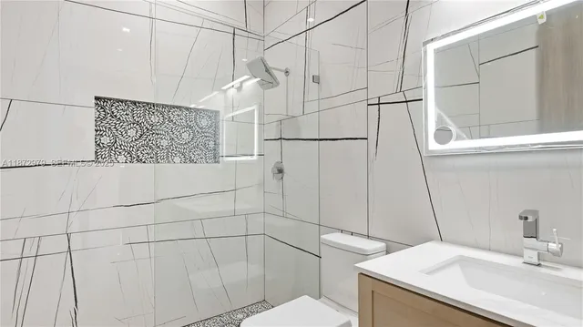 a bathroom with a sink toilet and shower