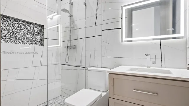 a bathroom with a sink toilet and shower