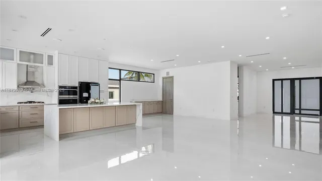 a kitchen with stainless steel appliances refrigerator and cabinets