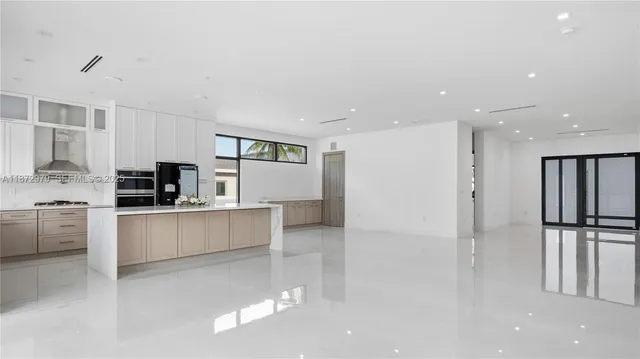 a kitchen with stainless steel appliances refrigerator and microwave