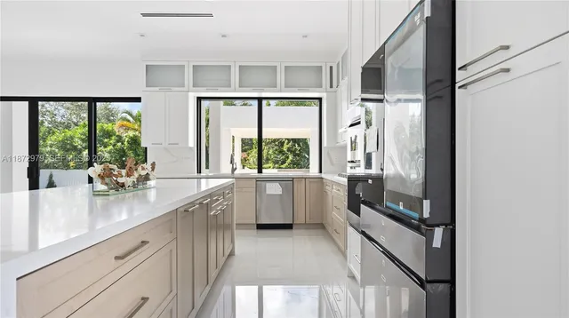 a kitchen with a large window and a sink