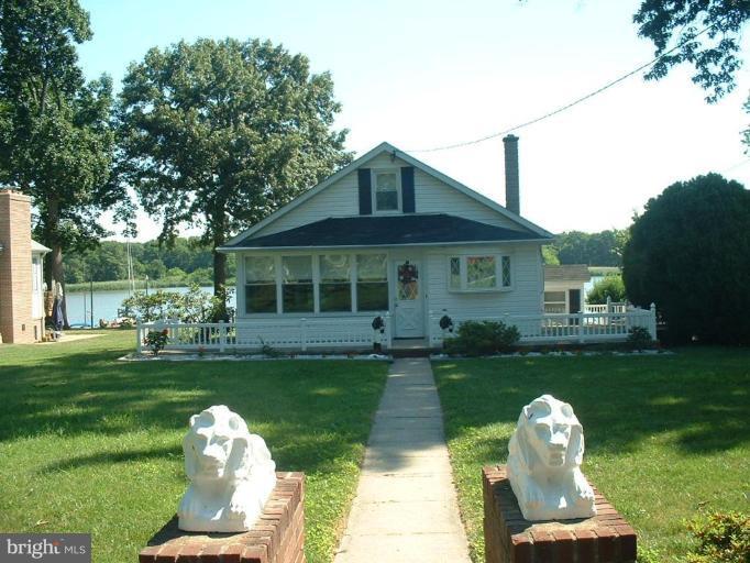 1601 Wilson Point Road Middle River, MD 21220 - Photo 1 of 17 a front view of a house with a yard garage and outdoor seating