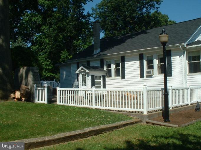 1601 Wilson Point Road Middle River, MD 21220 - Photo 2 of 17 a front view of a house with a garden and yard