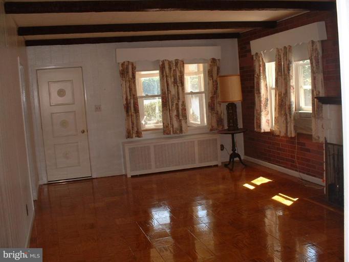 1601 Wilson Point Road Middle River, MD 21220 - Photo 8 of 17 a view of an empty room with wooden floor and a window