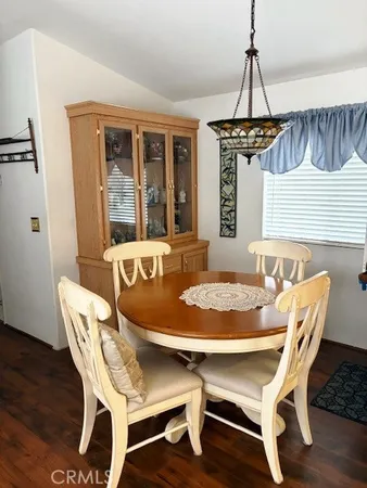 a dining room with furniture window and wooden floor