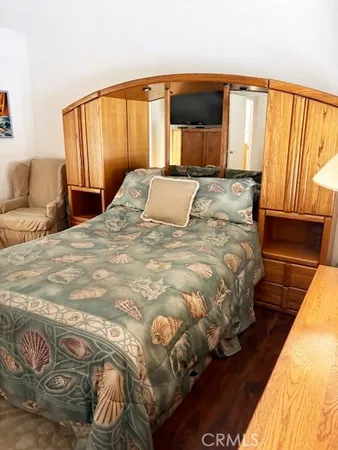 a large bed sitting in a bedroom next to a window