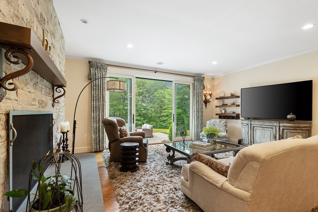 27 Whitehall Circle Beverly, MA 01915 - Photo 13 of 42 a living room with furniture a flat screen tv and a floor to ceiling window