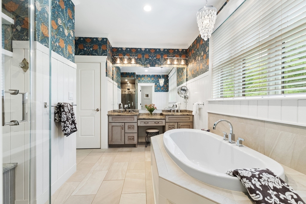 27 Whitehall Circle Beverly, MA 01915 - Photo 17 of 42 a bathroom with a sink a mirror and a bathtub