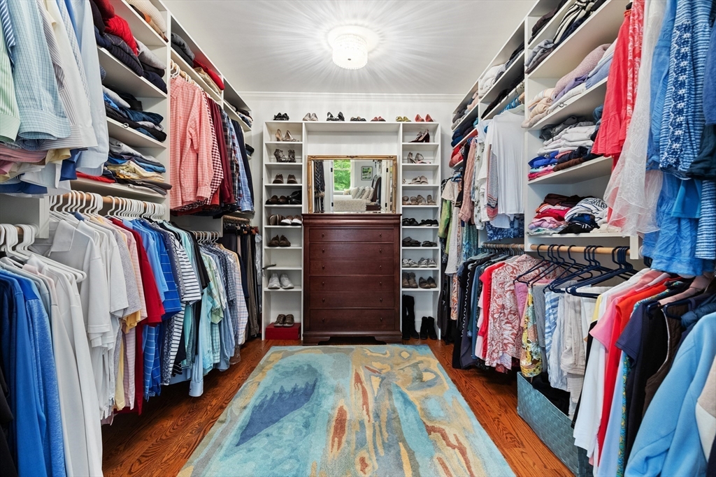 27 Whitehall Circle Beverly, MA 01915 - Photo 18 of 42 a view of walk in closet with clothes and shoes